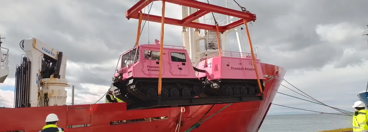 Tracked Antarctic vehicle being loaded onto a polar supply vessel in Punta Arenas